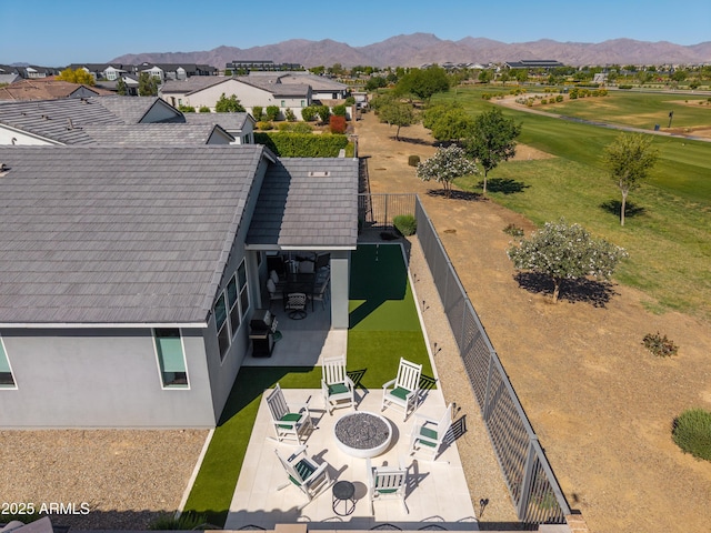 drone / aerial view featuring view of golf course and a mountain view