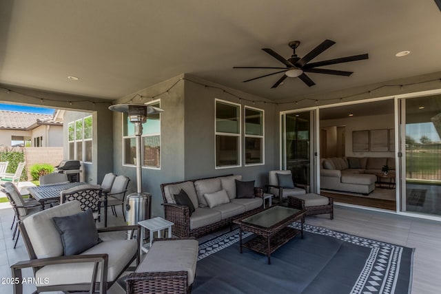 view of patio with a ceiling fan, outdoor lounge area, fence, and outdoor dining space