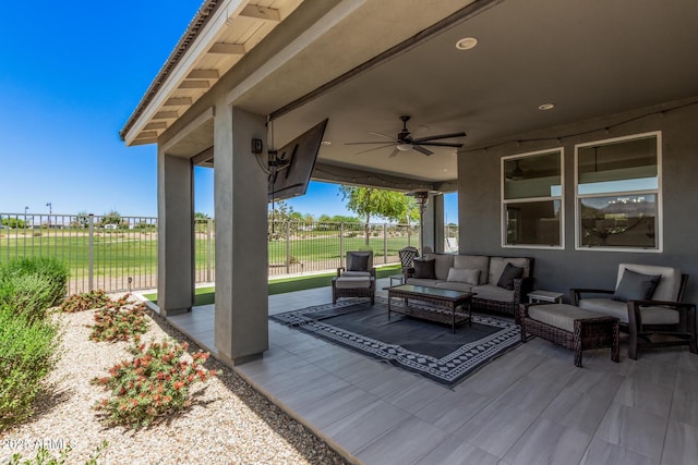 view of patio featuring a ceiling fan, fence, and an outdoor hangout area