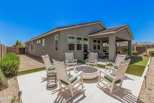 view of patio featuring a fenced backyard and an outdoor fire pit