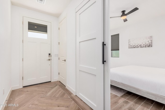 interior space with visible vents, baseboards, and ceiling fan