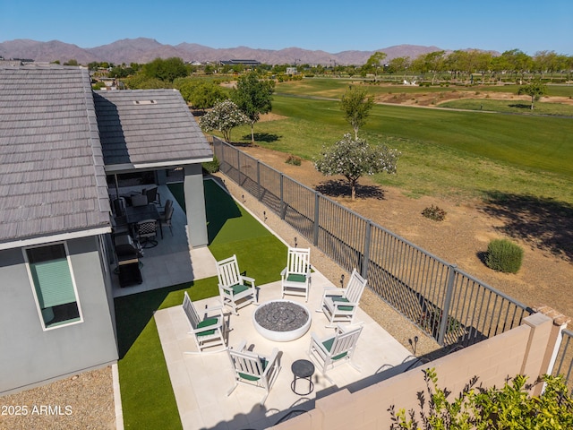 bird's eye view with view of golf course and a mountain view