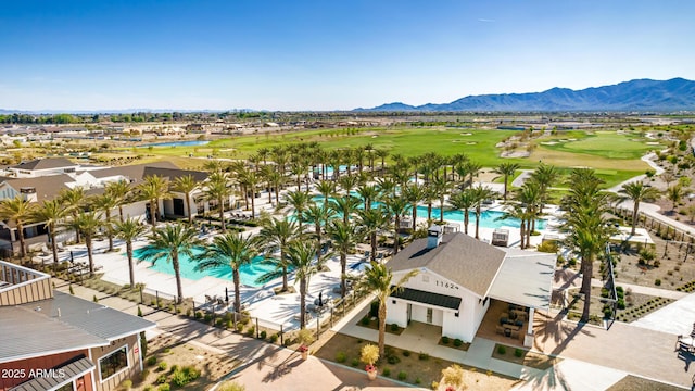 drone / aerial view with a residential view, a water and mountain view, and golf course view