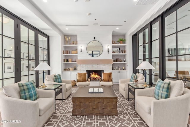 living room with recessed lighting, visible vents, built in features, and a fireplace