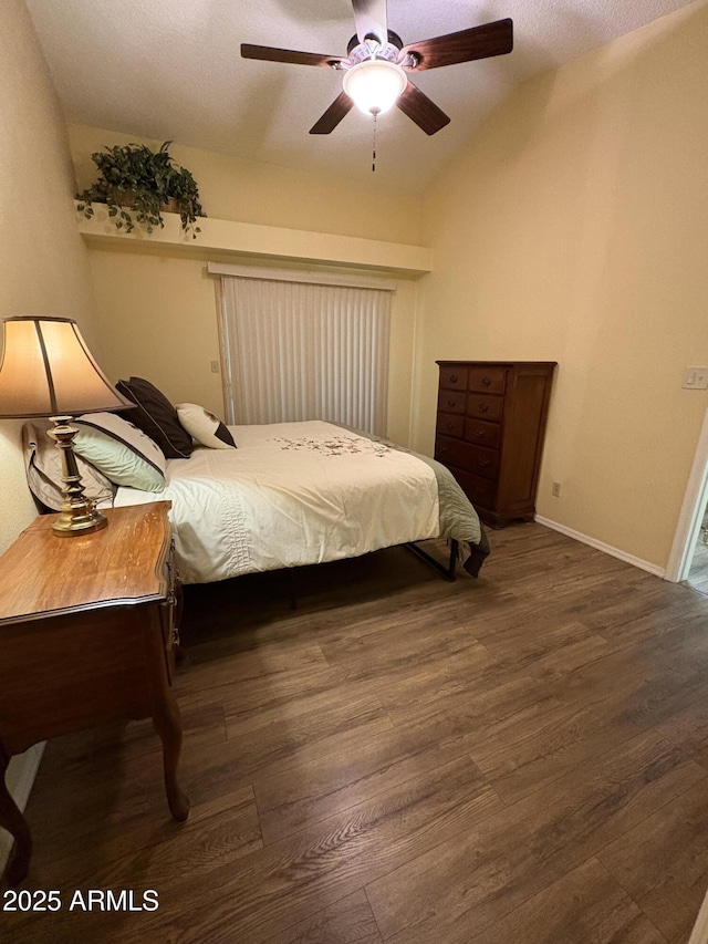 bedroom with ceiling fan, dark hardwood / wood-style flooring, and vaulted ceiling