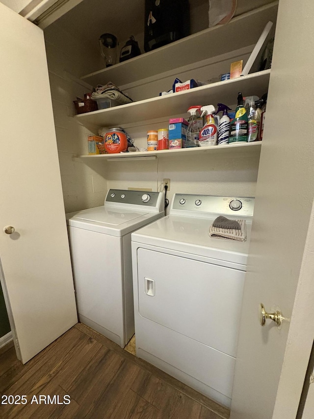 laundry area with washer and clothes dryer and wood-type flooring