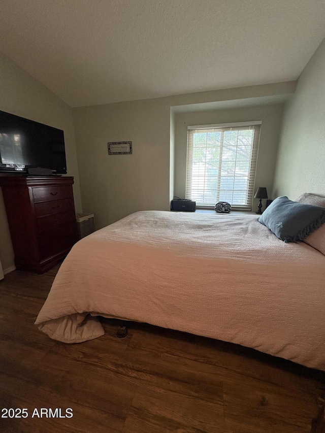 bedroom with dark hardwood / wood-style flooring