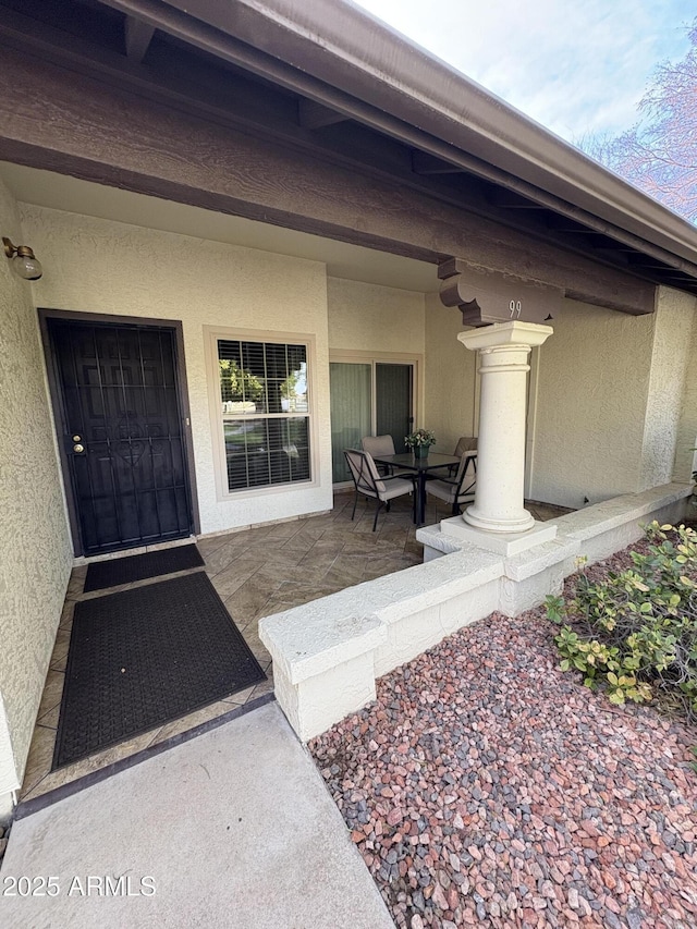 doorway to property with a patio