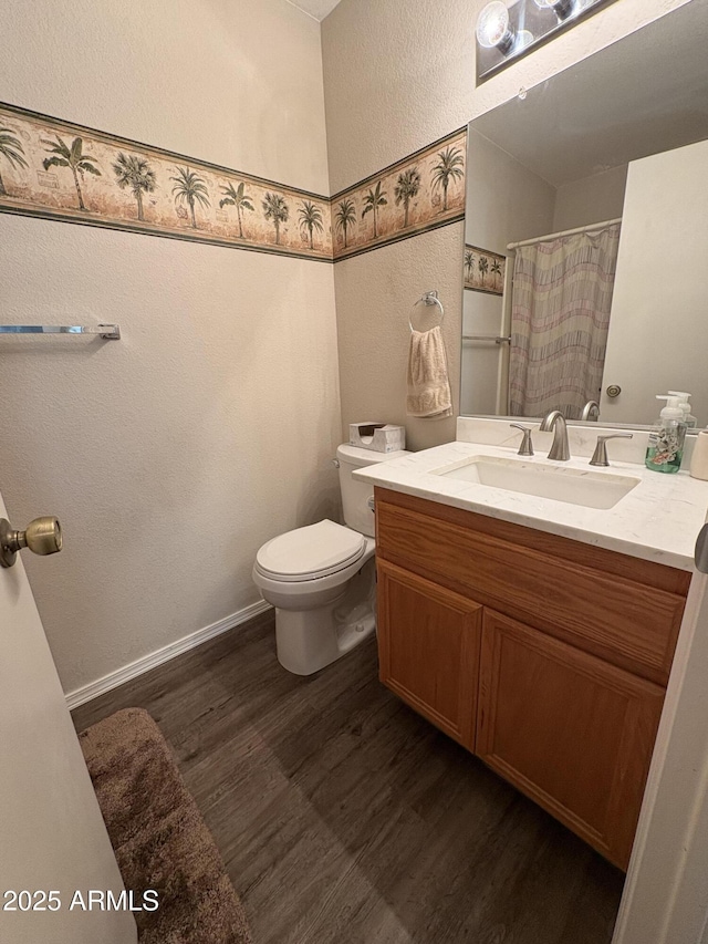 bathroom with wood-type flooring, toilet, and vanity