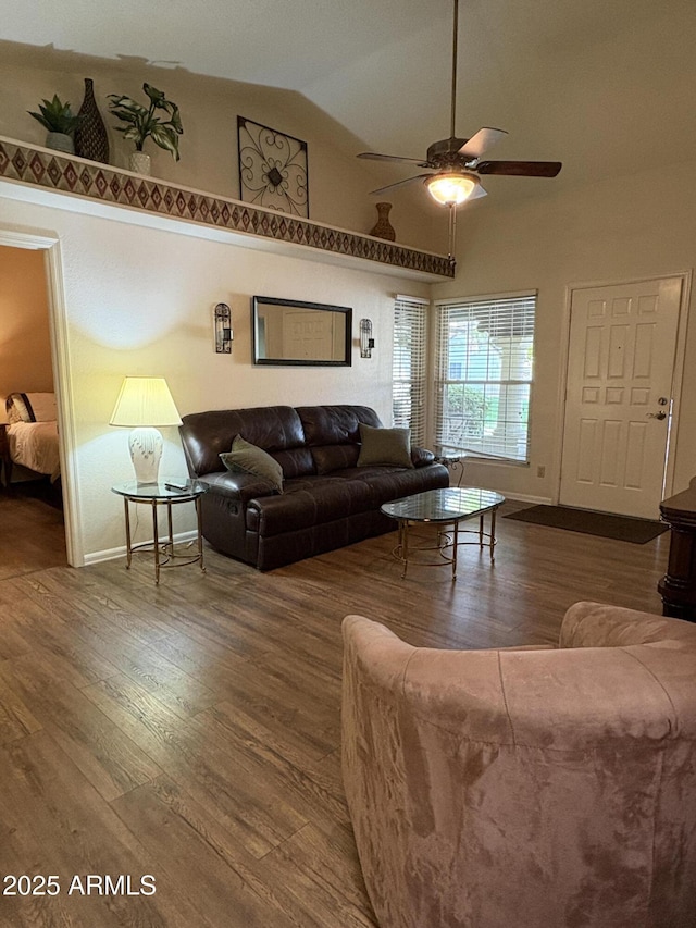 living room with hardwood / wood-style flooring, ceiling fan, and high vaulted ceiling