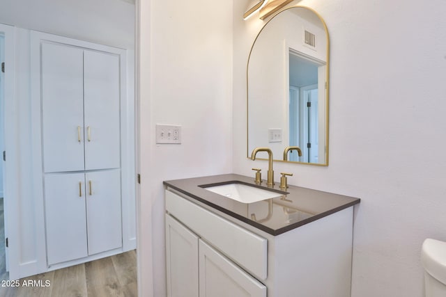 5510 E Dallas St, Mesa, AZ 85205 - bathroom featuring vanity, wood finished floors, and toilet