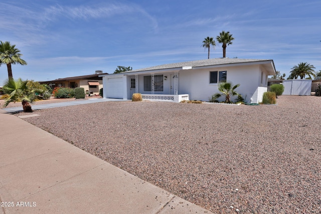 5510 E Dallas St, Mesa, AZ 85205 - ranch-style house featuring a garage, a porch, driveway, and stucco siding