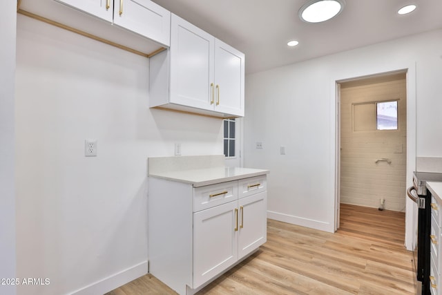 5510 E Dallas St, Mesa, AZ 85205 - kitchen featuring baseboards, white cabinets, light countertops, light wood finished floors, and recessed lighting