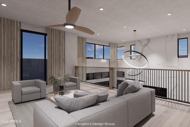 living room with ceiling fan and light hardwood / wood-style floors