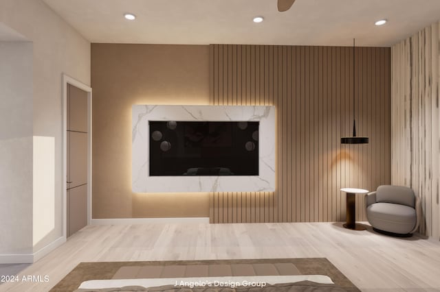 unfurnished living room featuring hardwood / wood-style flooring and ceiling fan