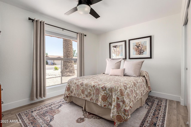 5211 E Winchcomb Dr, Scottsdale, AZ 85254 - bedroom with multiple windows, light wood finished floors, and a ceiling fan