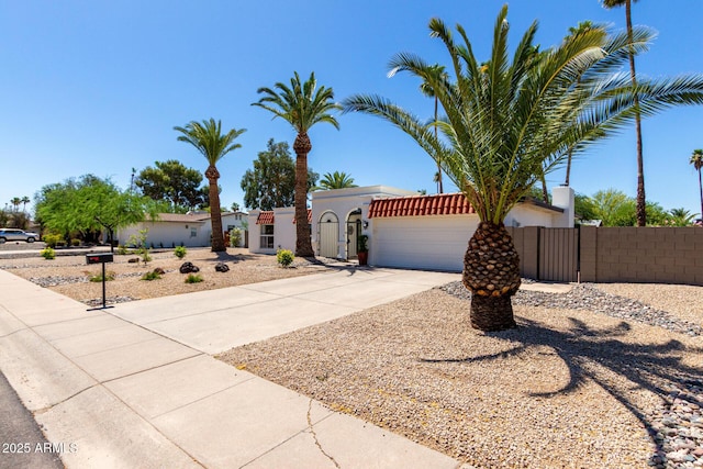 5211 E Winchcomb Dr, Scottsdale, AZ 85254 - view of front of home with concrete driveway, a garage, a gate, and stucco siding