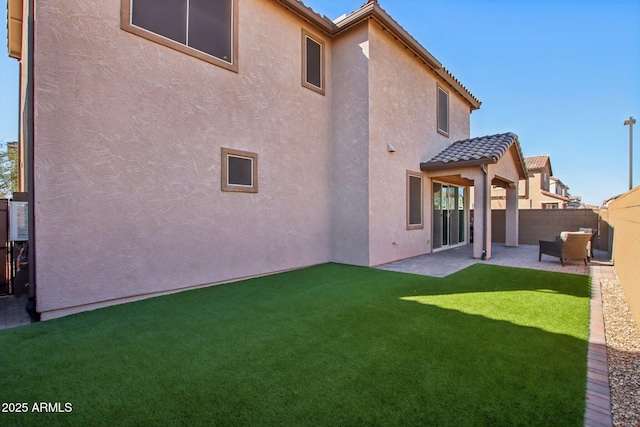 back of house with a yard and a patio area