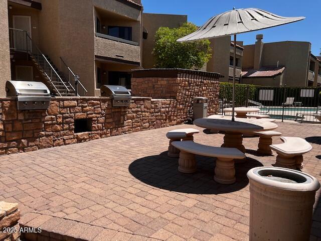 2228 N 52nd St Unit 140, Phoenix, AZ 85008 - view of patio featuring a community pool and stairway