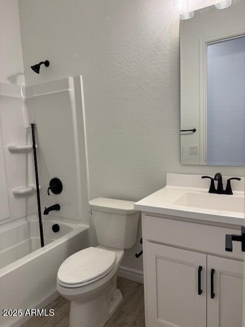 full bathroom with vanity, tub / shower combination, wood finished floors, and toilet