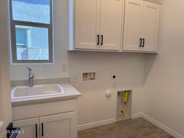 laundry area with washer hookup, hookup for a gas dryer, cabinet space, a sink, and electric dryer hookup