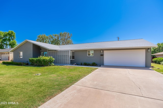 single story home featuring an attached garage, driveway, and a front lawn