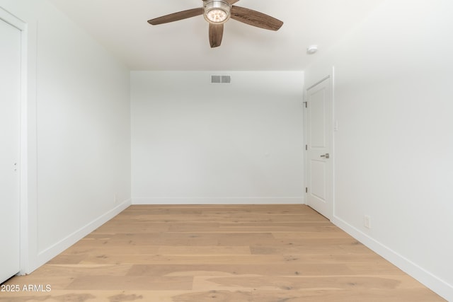 empty room featuring a ceiling fan, light wood-style flooring, and baseboards
