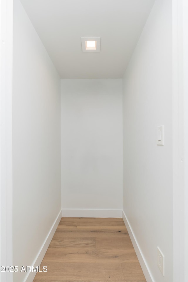 empty room with light wood-style floors and baseboards