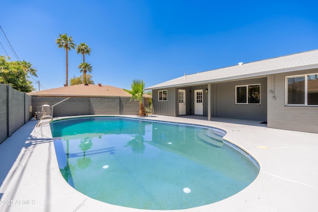view of swimming pool with a fenced backyard and a patio area
