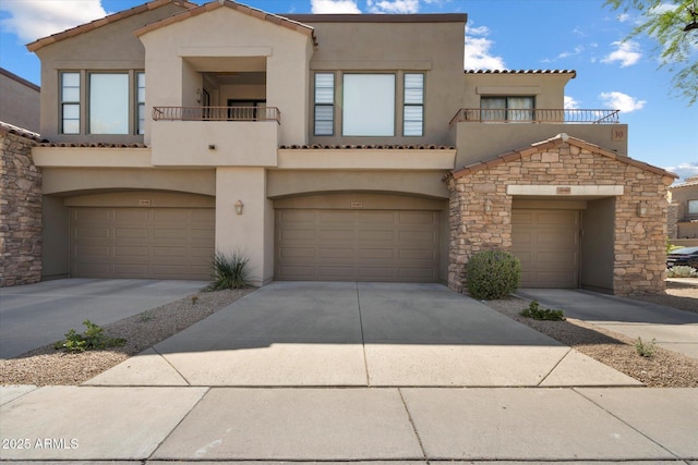 townhome / multi-family property with concrete driveway, a tiled roof, a balcony, and stucco siding