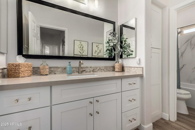 bathroom featuring vanity, toilet, and wood finished floors