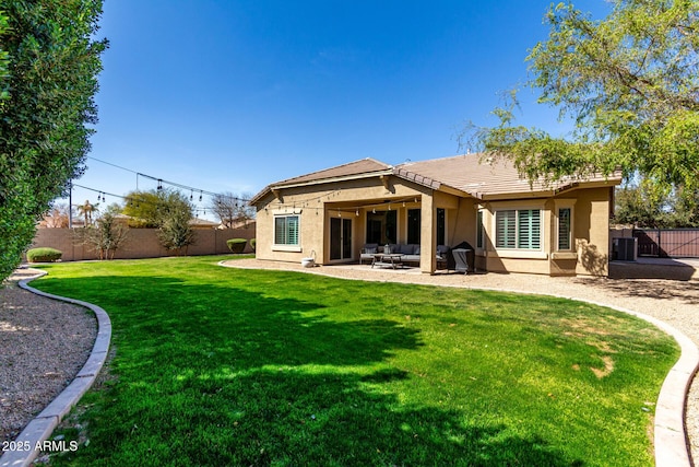 back of property featuring a patio, a lawn, a fenced backyard, and stucco siding