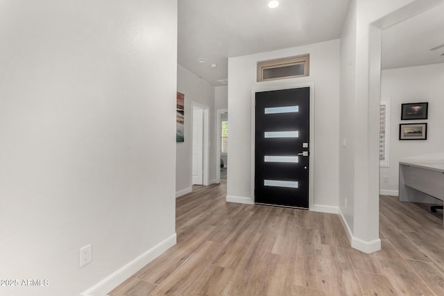 entrance foyer featuring baseboards and light wood-style floors