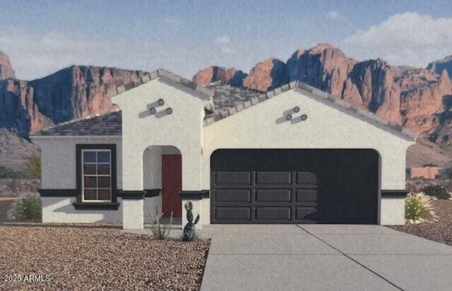 25425 W Graham Trl, Buckeye, AZ 85326 - view of front of property featuring a mountain view, an attached garage, stucco siding, and concrete driveway