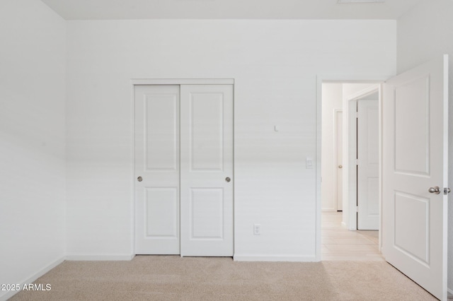 25425 W Graham Trl, Buckeye, AZ 85326 - unfurnished bedroom featuring a closet, baseboards, and light colored carpet