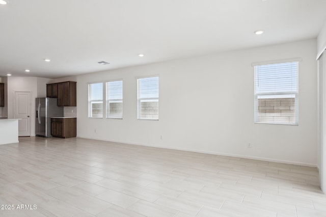 25425 W Graham Trl, Buckeye, AZ 85326 - unfurnished living room featuring recessed lighting and baseboards
