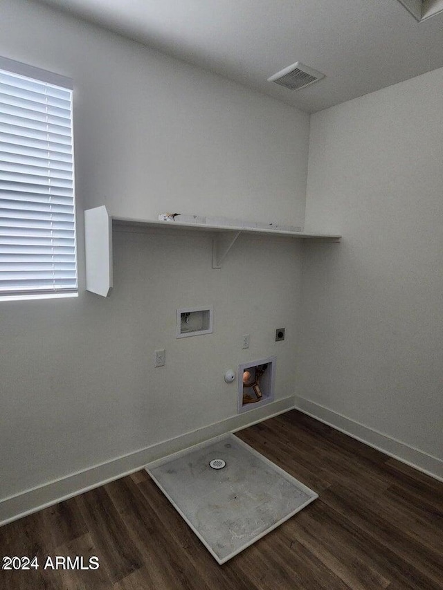 laundry room featuring gas dryer hookup, hookup for an electric dryer, washer hookup, and dark hardwood / wood-style floors