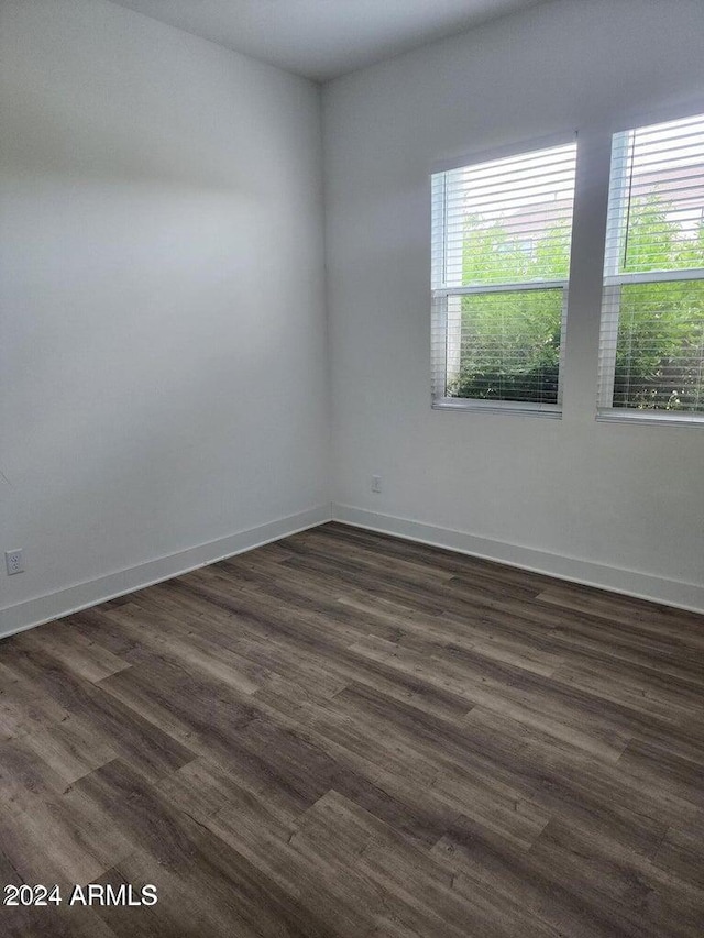 empty room with dark hardwood / wood-style floors