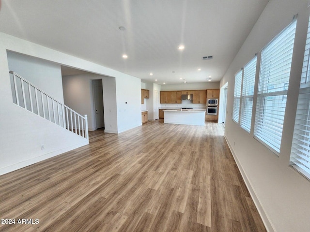 unfurnished living room with light wood-type flooring