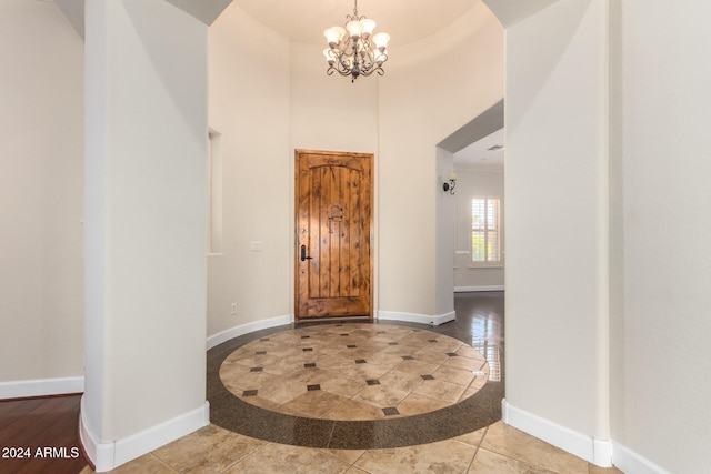 foyer entrance featuring tile patterned flooring and an inviting chandelier