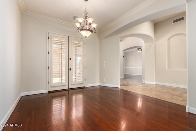 unfurnished room featuring french doors, ceiling fan with notable chandelier, ornamental molding, and light hardwood / wood-style flooring