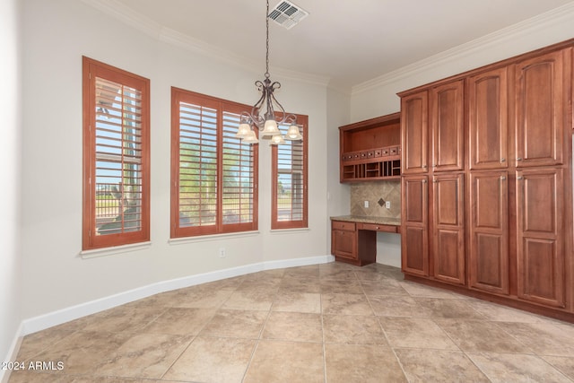 unfurnished dining area featuring built in desk, a notable chandelier, light tile patterned flooring, and ornamental molding