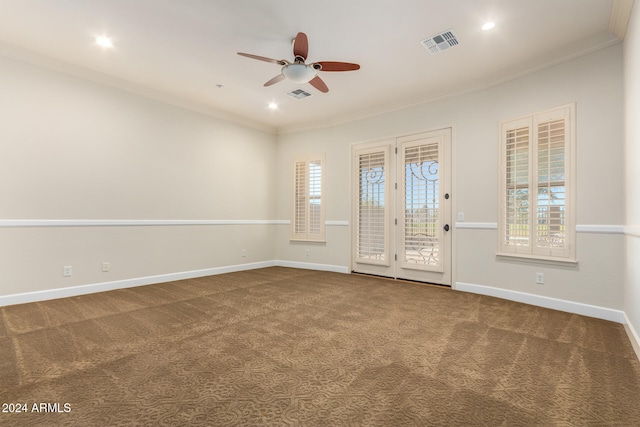 unfurnished room featuring carpet floors, ceiling fan, and crown molding