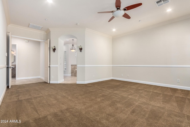 spare room with ceiling fan, carpet flooring, and crown molding