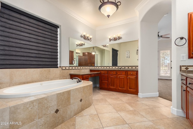 bathroom with tile patterned flooring, tiled bath, vanity, ceiling fan, and crown molding