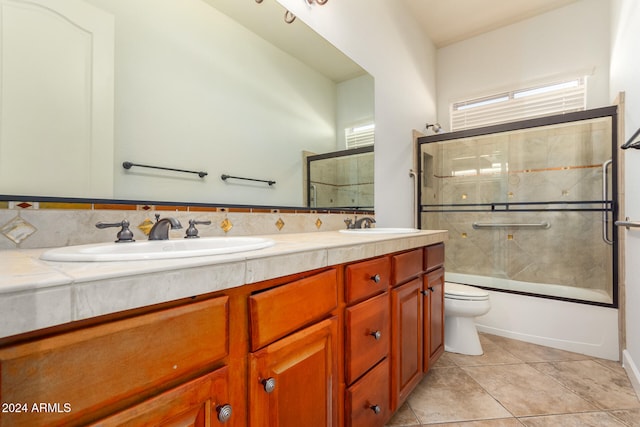 full bathroom with tile patterned flooring, enclosed tub / shower combo, toilet, and vanity