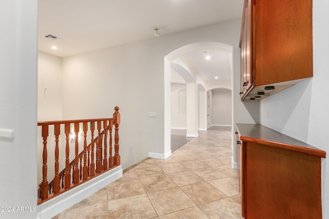 corridor with light tile patterned flooring