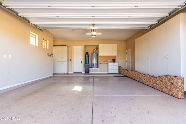 garage with a garage door opener and gas water heater