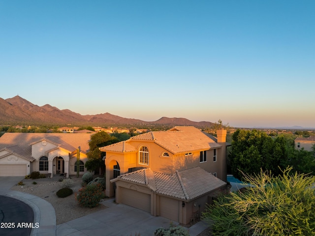 9571 E Nittany Dr, Scottsdale, AZ 85255 - mediterranean / spanish home featuring an attached garage, concrete driveway, stucco siding, a tile roof, and a mountain view