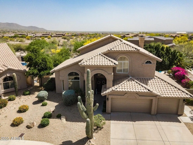 9571 E Nittany Dr, Scottsdale, AZ 85255 - mediterranean / spanish-style house featuring a tile roof, driveway, an attached garage, stucco siding, and a chimney